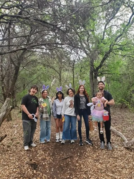 Neighbors and kids wearing bunny ears on the trail during the spring egg hunt.
